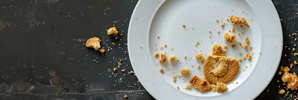an empty plate with cookie crumbs