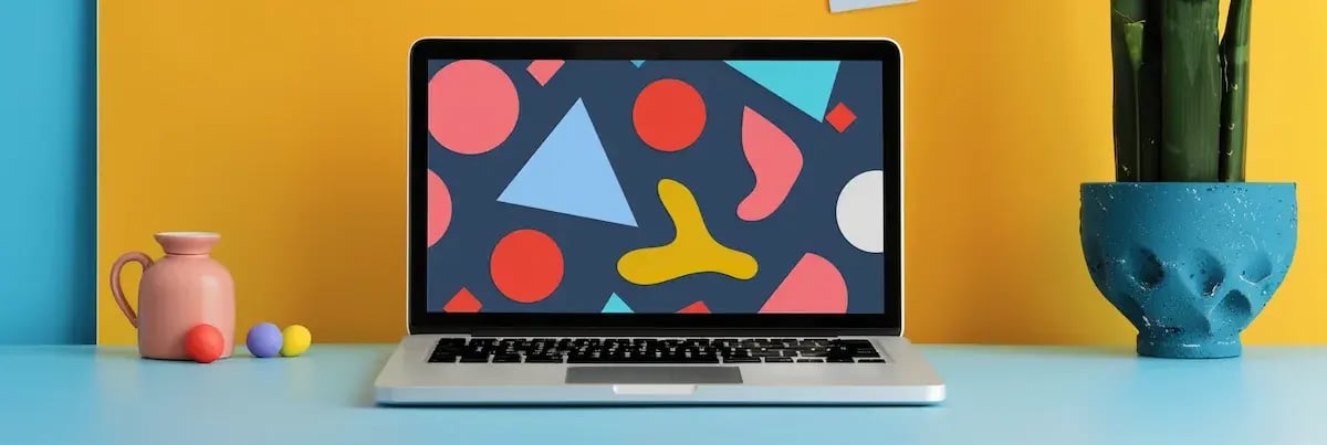 laptop in colorful space with colorful shapes on screen