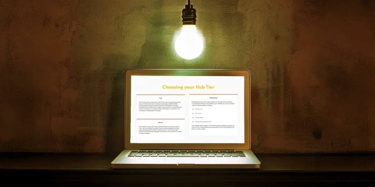 laptop on desk with hubspot content hub tiers on screen.