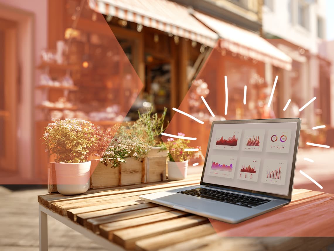a laptop sitting on a tablet outside a small business. the screen displays various charts in a reporting dashboard.