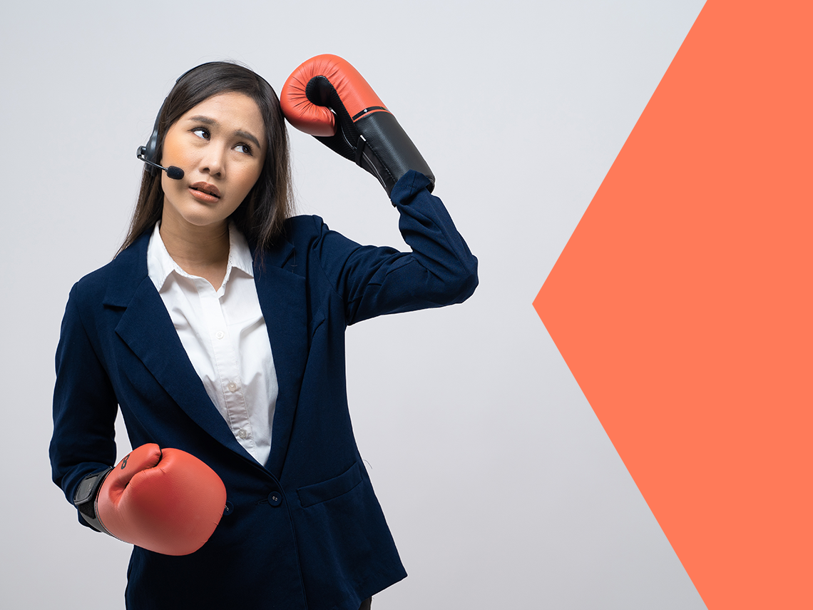 a customer service rep wearing boxing gloves and looking befuddled